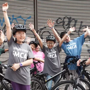 Group of teens in Chinatown YMCA program riding bikes