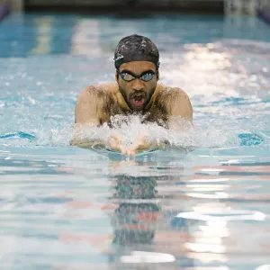 man swimming in a pool lane