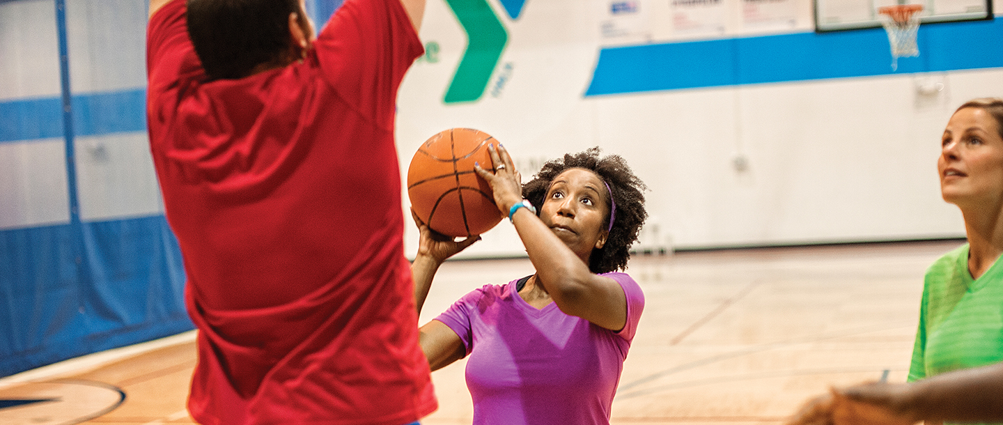 Adults playing basketball at the YMCA