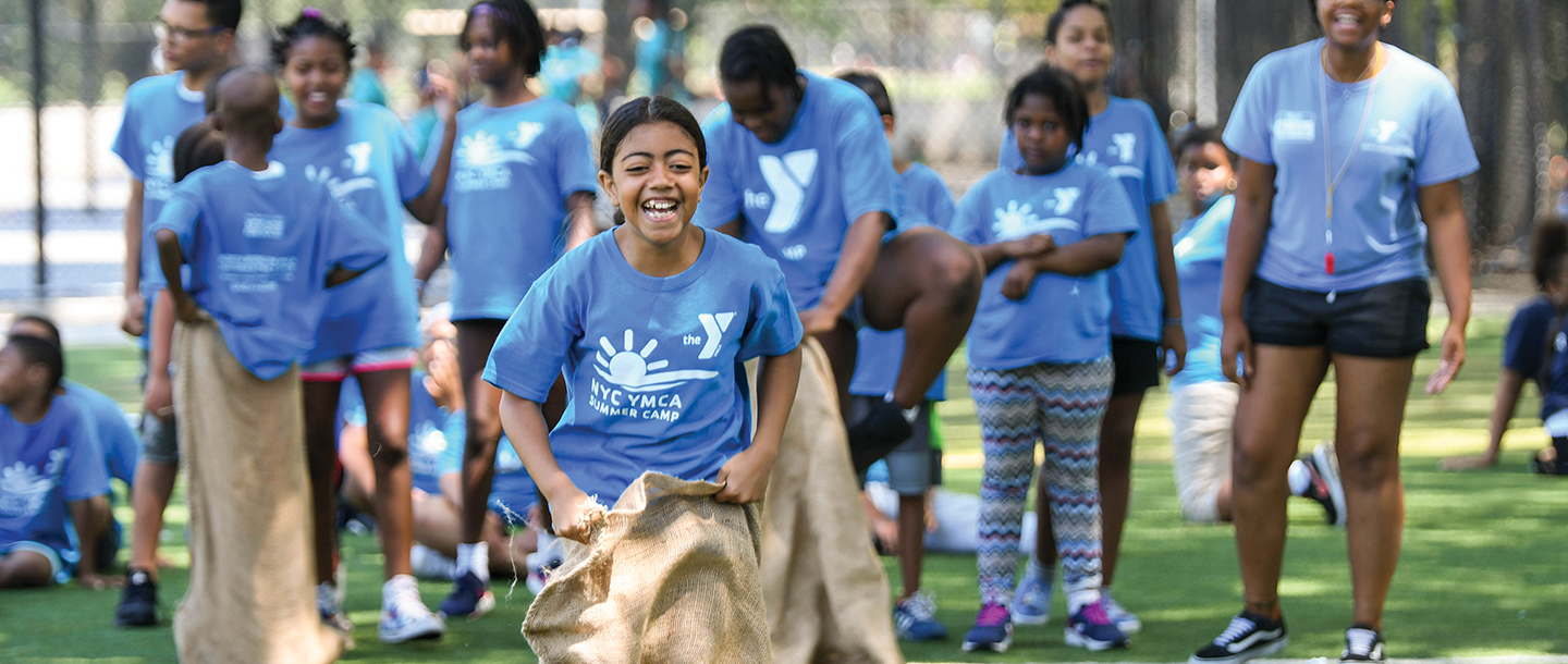 Summer camper playing game at YMCA day camp