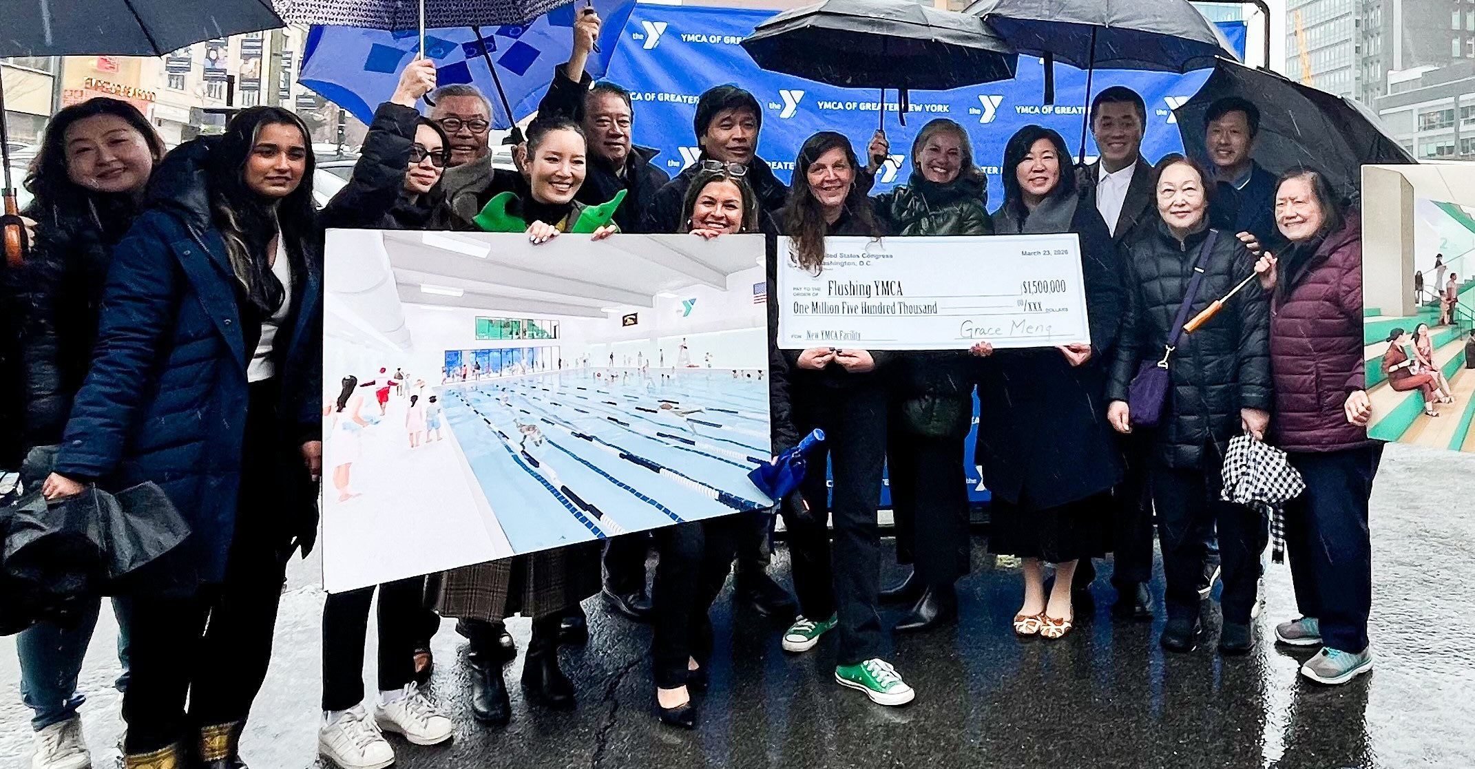 Group photo holding check under umbrellas