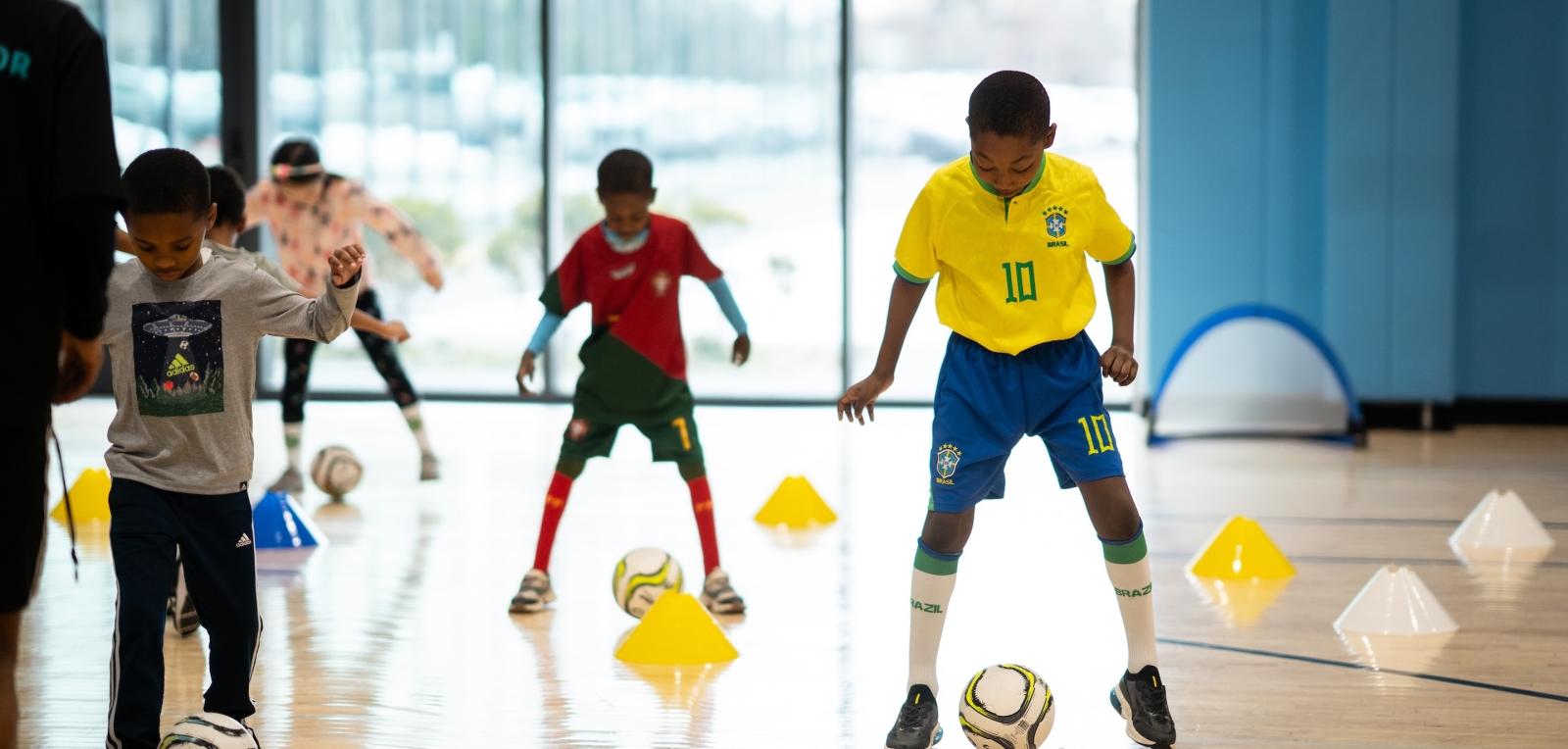 boys in gym with soccer balls