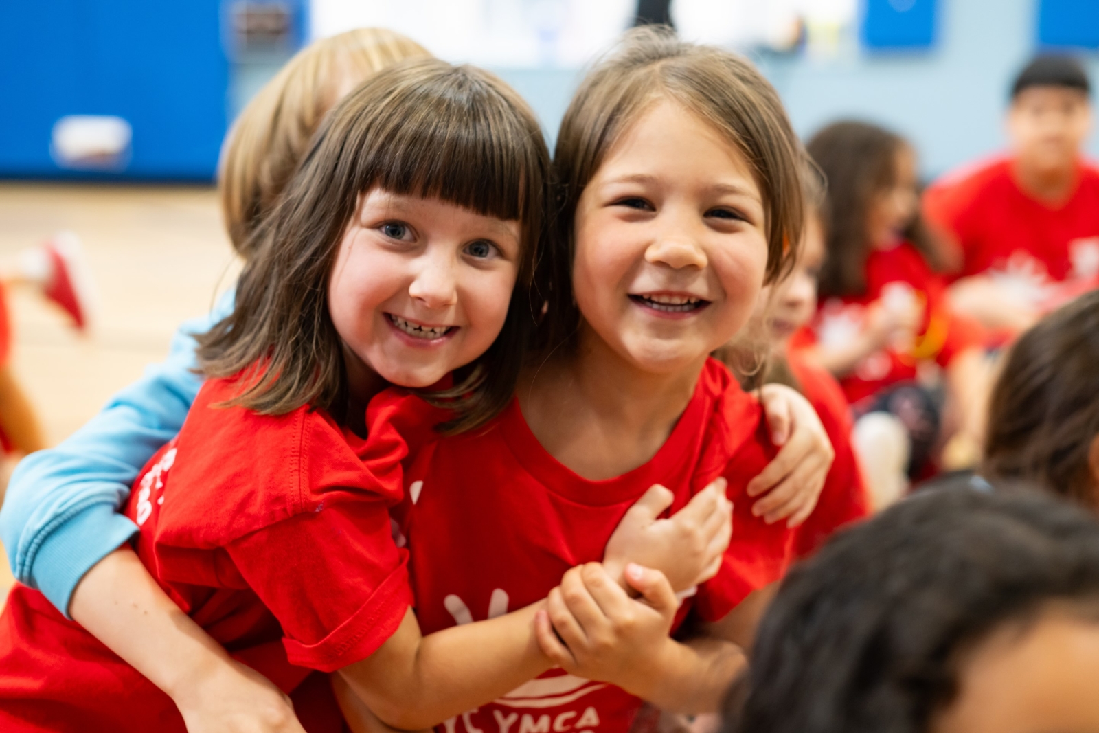 2 girls hug and smile