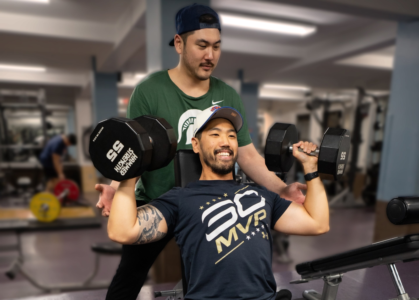 2 guys lifting weights