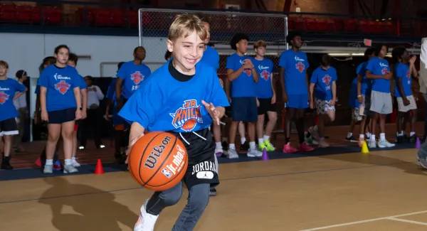 kid dribbling basketball