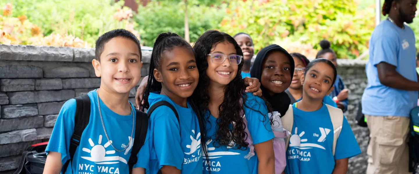 5 kids smiling in camp shirts