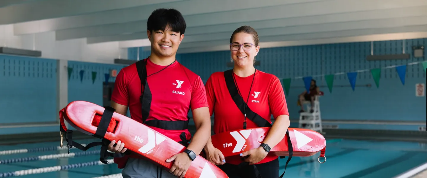 2 lifeguards stand by pool