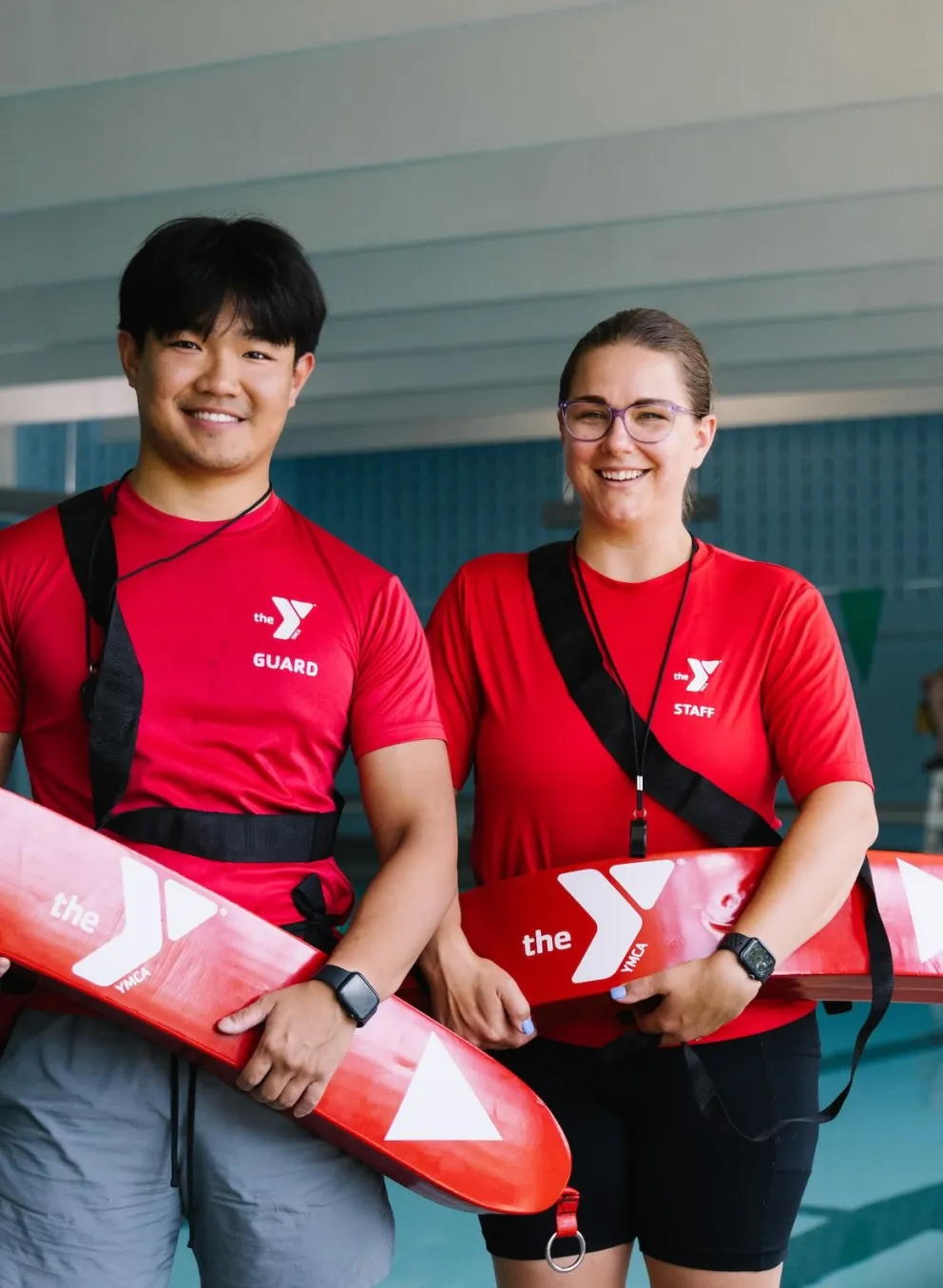 2 lifeguards stand by pool
