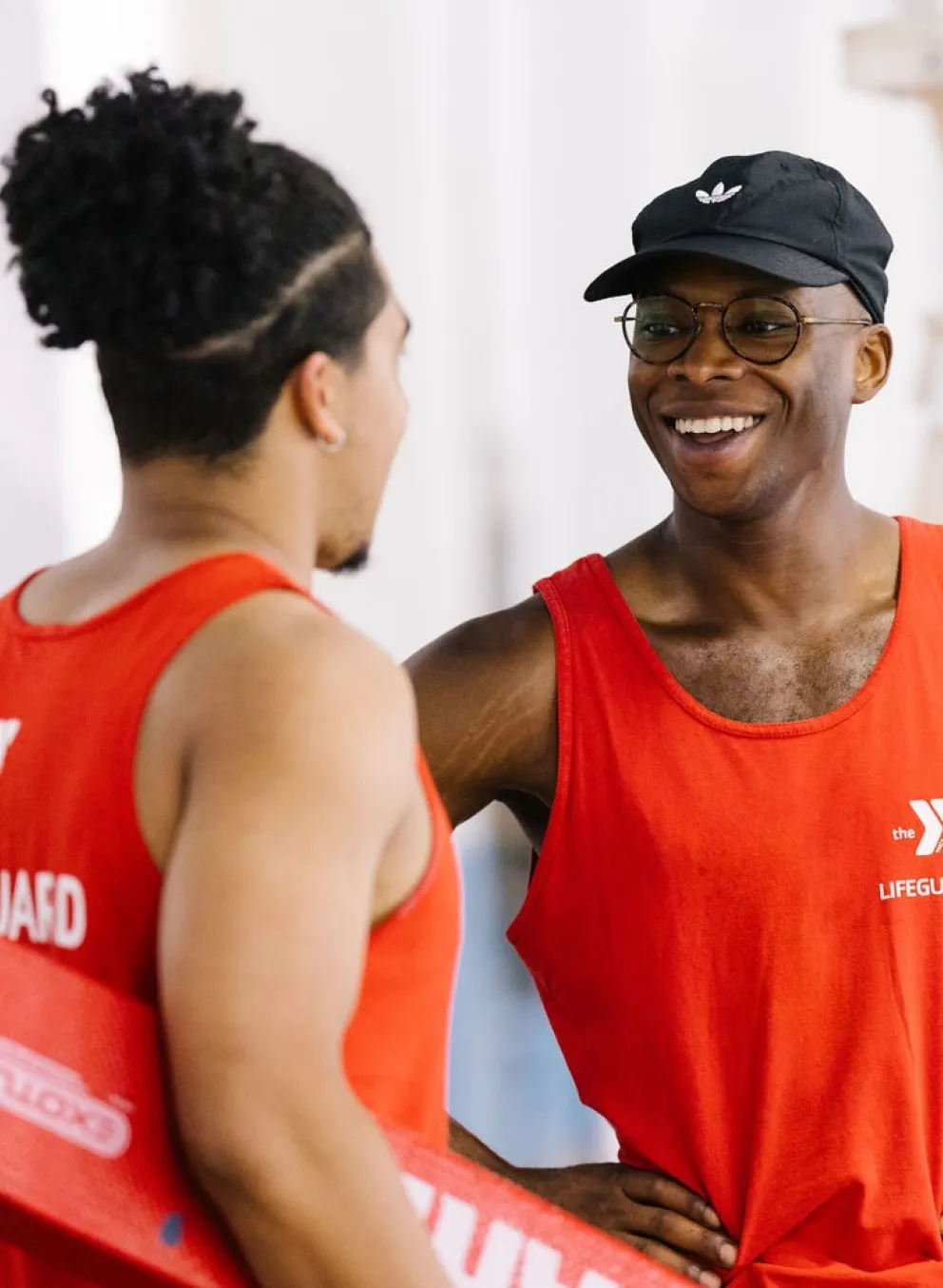2 lifeguards talk by pool
