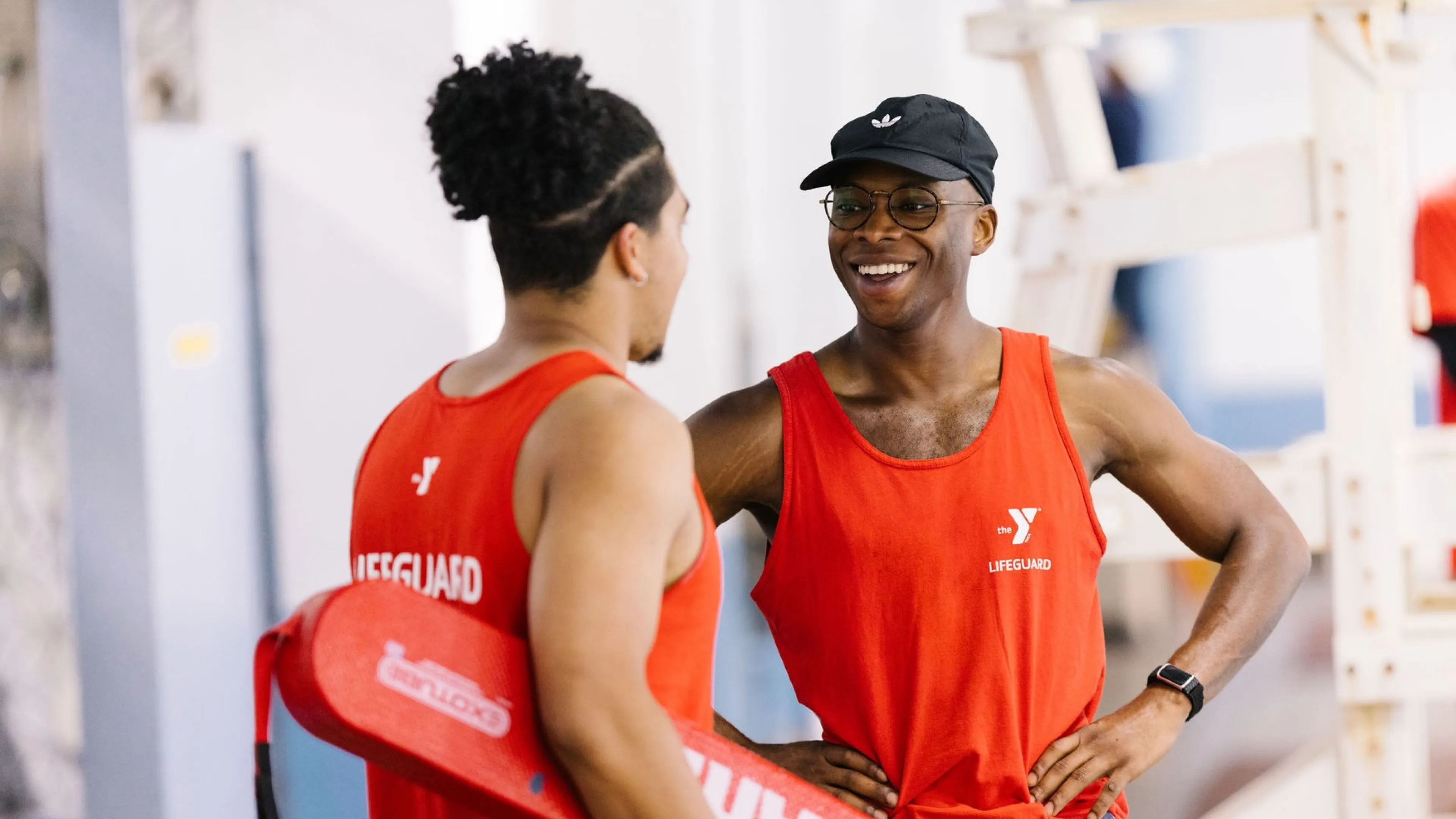 2 lifeguards talk by pool