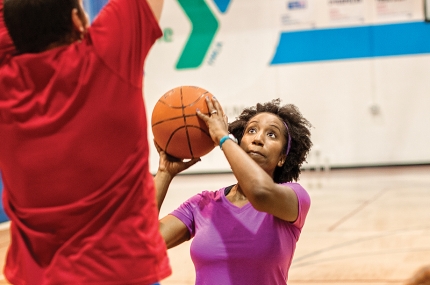 Adults playing basketball at YMCA