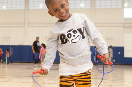 Kids learning exercise during youth sports class at the YMCA