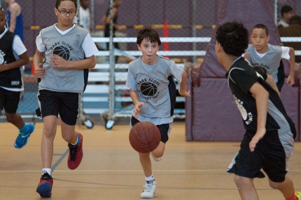 Kids playing basketball during youth sports class at the YMCA