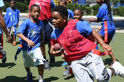 Campers at the YMCA playing flag football during youth sports