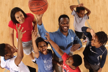 Kid playing basketball in youth sports class at the YMCA