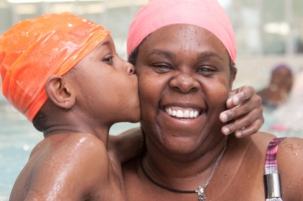 Mother and son swim in pool at YMCA