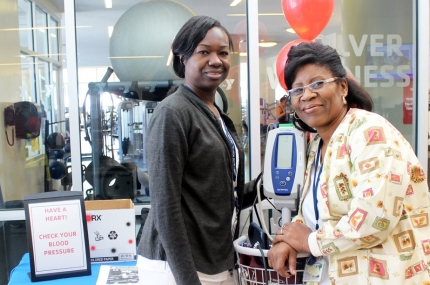 Two women with a blood pressure machine at the YMCA.