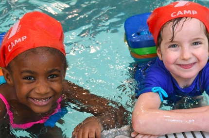 Two kids swimming at a YMCA Camp.