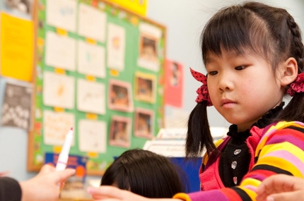 Preschool girl in UPK classroom at Flushing YMCA