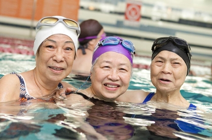 Three women in water exercise class at Chinatown YMCA pool