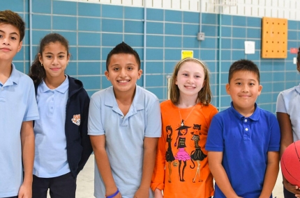 A group of kids in a gymnasium.