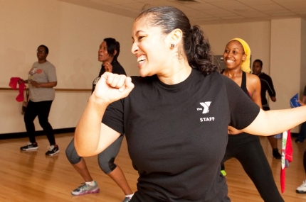 An instructor leads a zumba class at the YMCA.