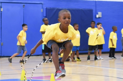 Camper at Jamaica YMCA basketball camp gym in Queens