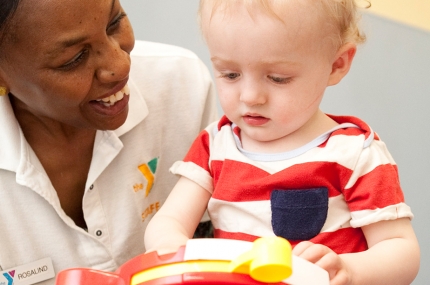 An infant and a YMCA staff member.