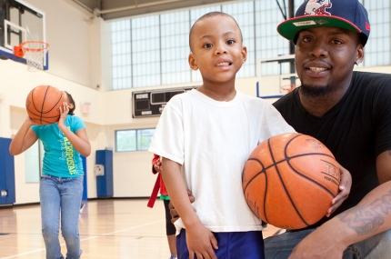 Father and son playing basketball at the YMCA