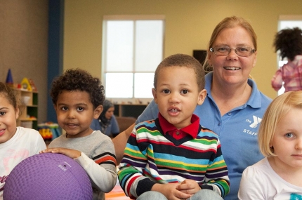 Group of kids with Child watch staff at YMCA