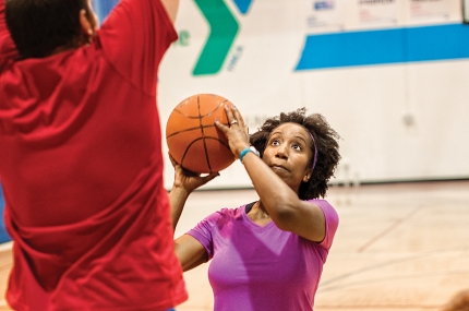 Adults playing basketball