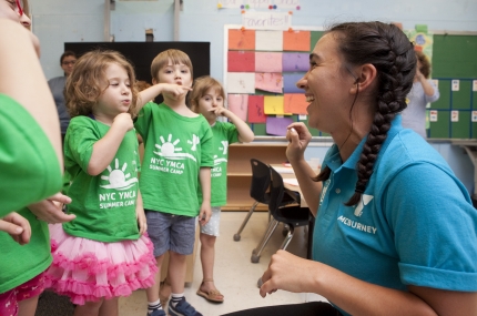 counselor and children singing