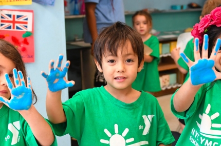 Summer campers with paint hands activity at YMCA day camp in Manhattan