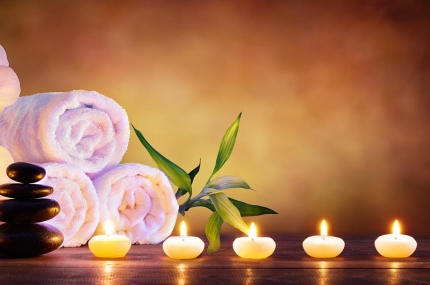 Massage therapy towels, stones, and candles
