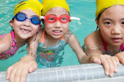 Three girls learning how to swim at YMCA