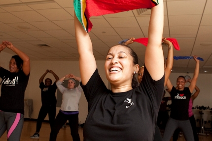 Zumba instructor with her arms raised
