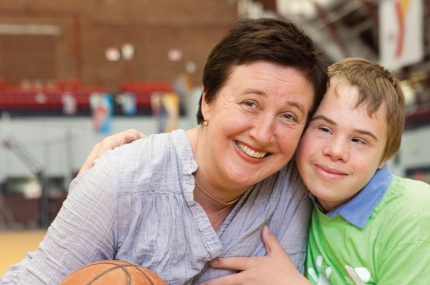 Son hugs mom at Park Slope Armory YMCA basketball court