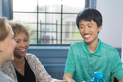 Man smiling during YMCA free English class at Flushing YMCA