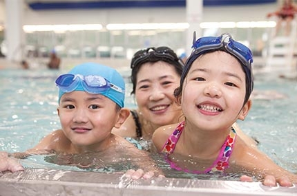 Family swimming at YMCA indoor pool