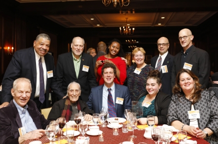 McBurney YMCA staff and board members gathered around table at Heritage Society dinner reception