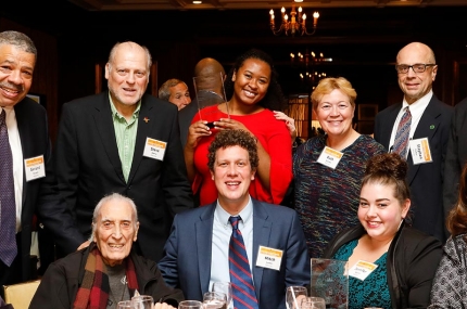 McBurney YMCA staff and board members gathered around table at Heritage Society event