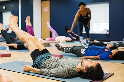 Students lying on yoga mats in Ridgewood YMCA studio