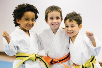 Three boys with karate belts at the Park Slope Armory YMCA