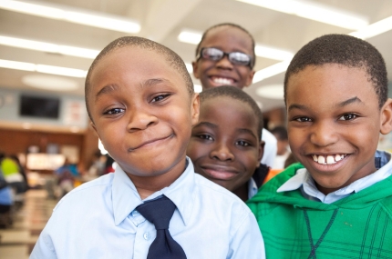 Group of boys smiling at YMCA afterschool program in NYC elementary school