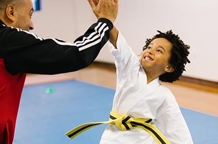 Karate kid gives coach high five