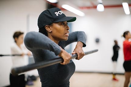 Woman lifting weight in strength training class for women at Bedstuy YMCA in Brooklyn