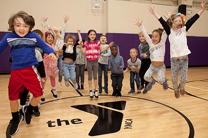 Class of preschoolers jump in YMCA gym