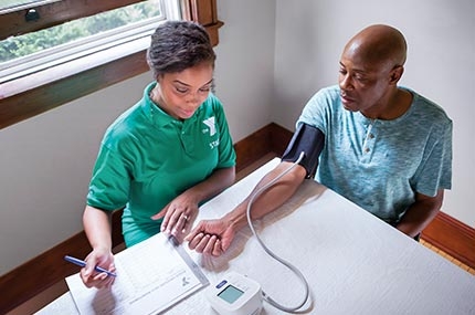 YMCA staff gives free blood pressure screening