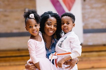 Mom with ballerina and karate kid at West Side YMCA gym