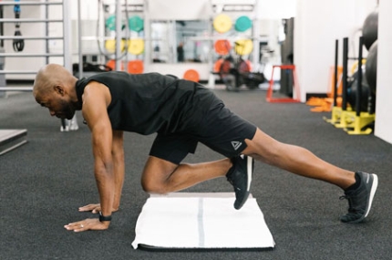 YMCA instructor demonstrating mountain climbers